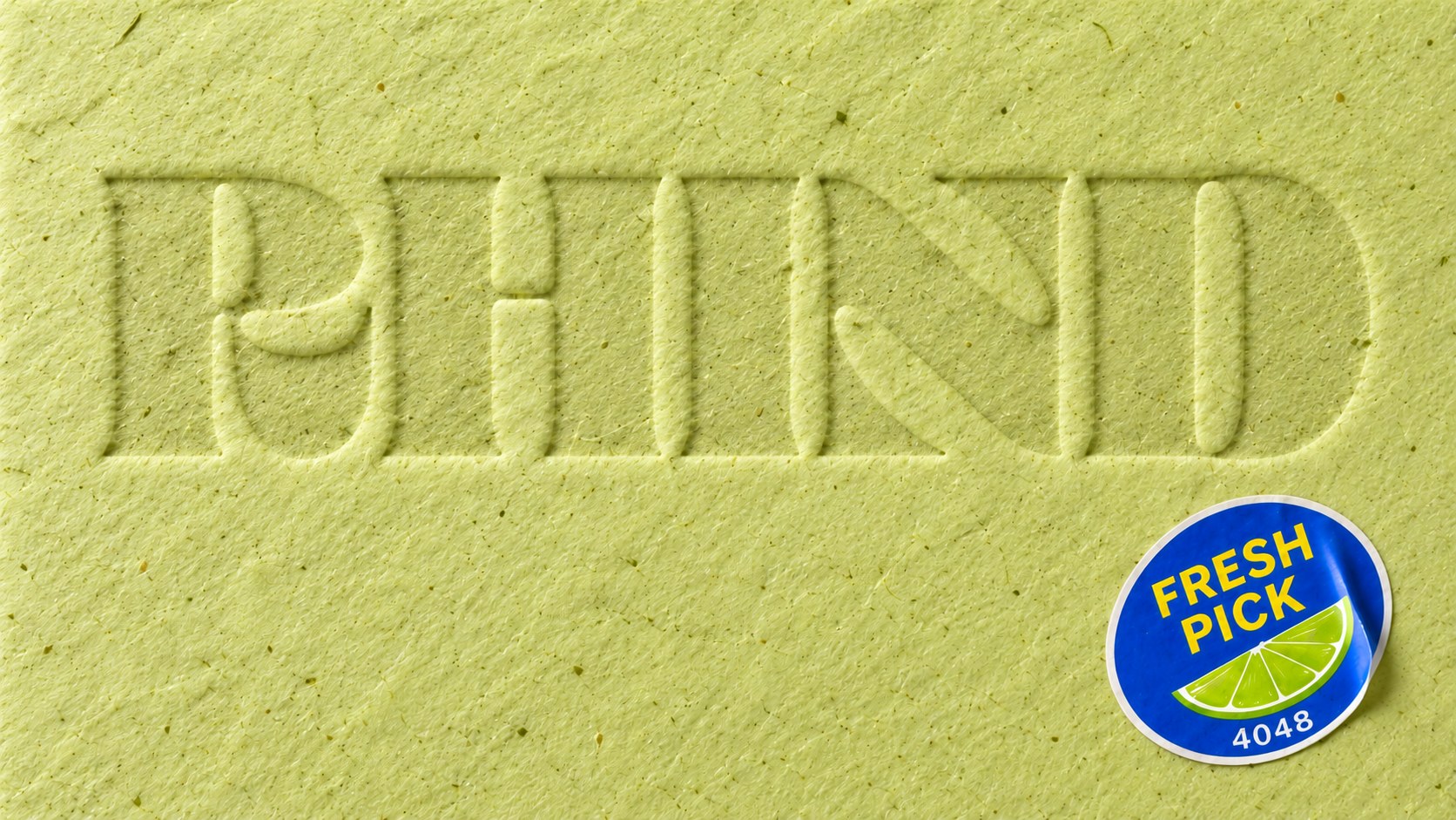 RHIND wordmark blind debossed into lime-green paper with a Fresh Pick sticker